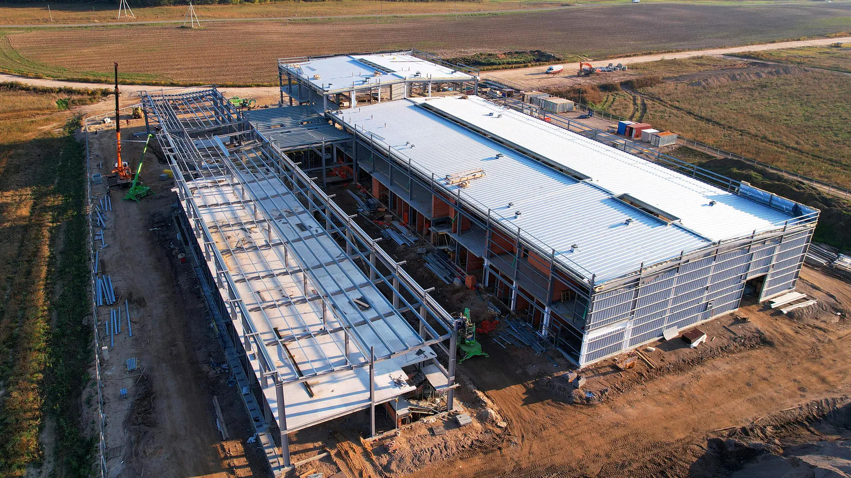 Modern industrial steel structure warehouse exterior with tapered portal rigid frame and metal cladding