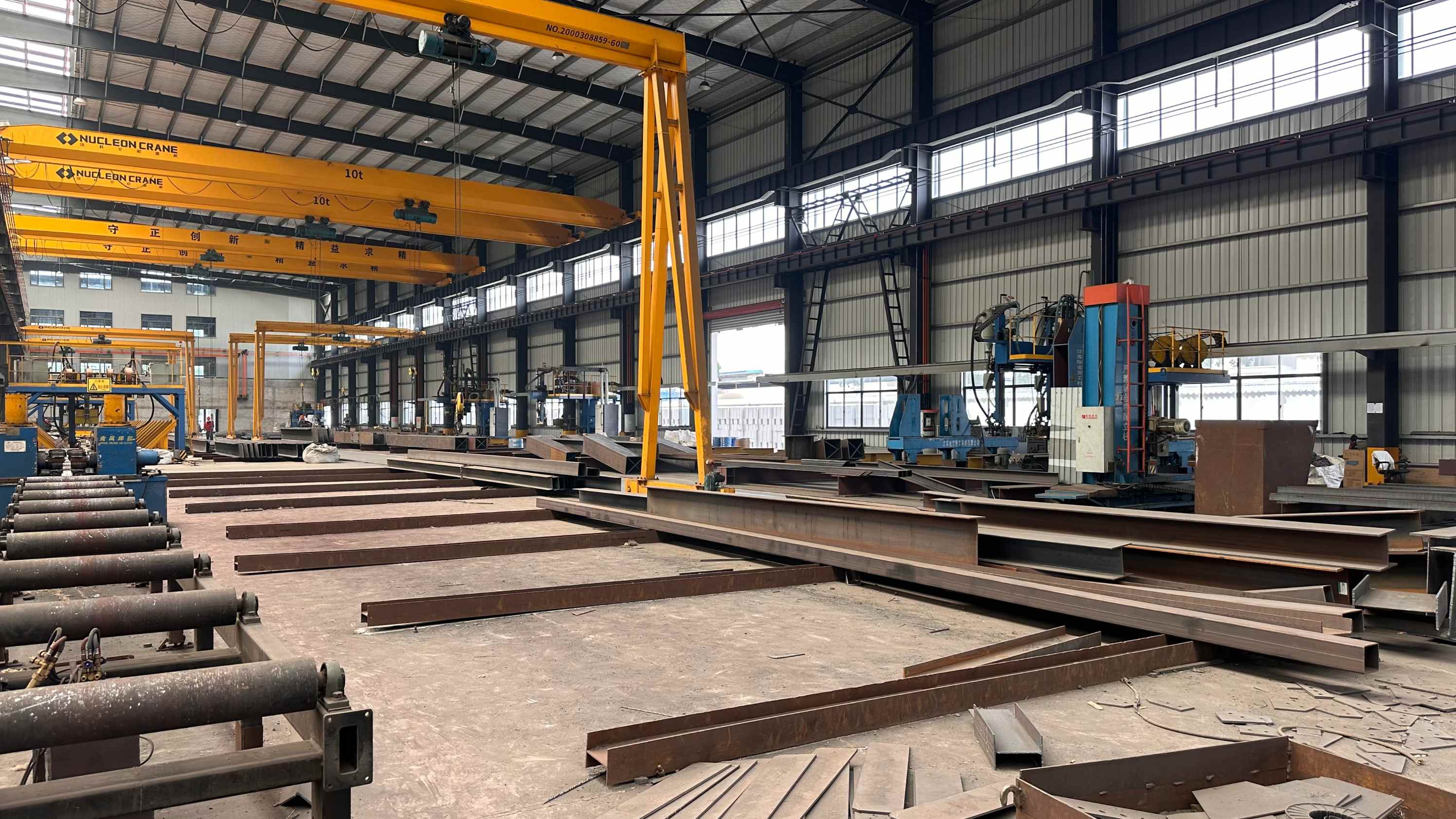 Automated submerged arc welding gantry fabricating heavy structural steel H-beams in a Chinese manufacturing plant