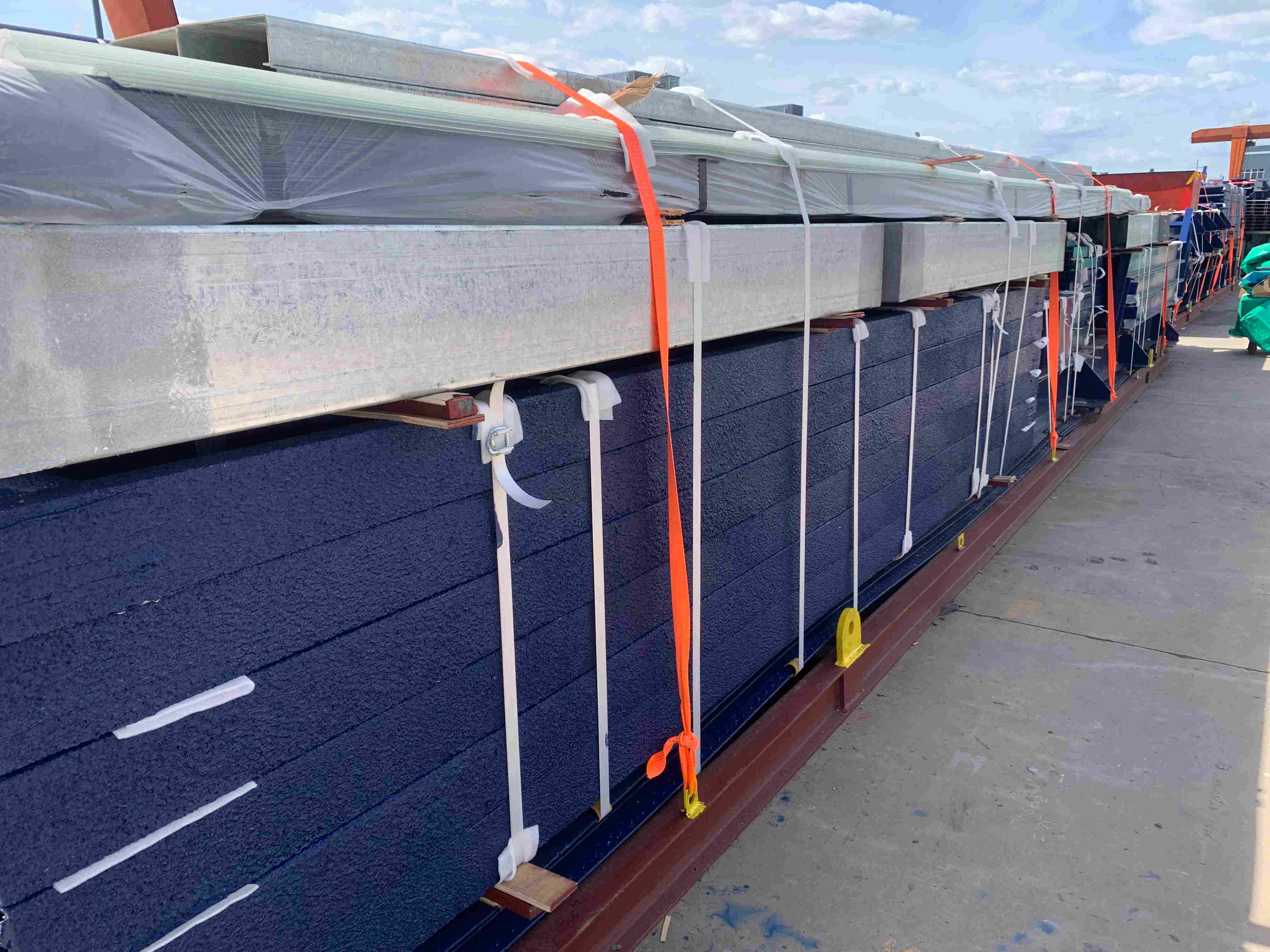 Nested cold-formed Z-purlin bundles strapped with high-tensile steel banding and corner protectors
