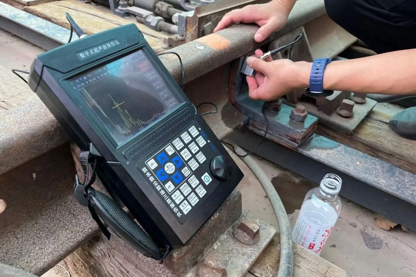 Quality control inspector performing ultrasonic testing on a full-penetration structural steel weld joint